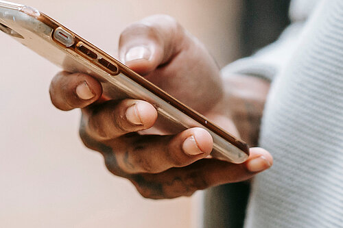 A hand holding a mobile phone