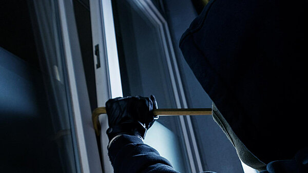 Burglar attempting to pry open a window